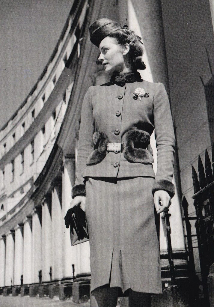 black and white image of a lady in tailored suit